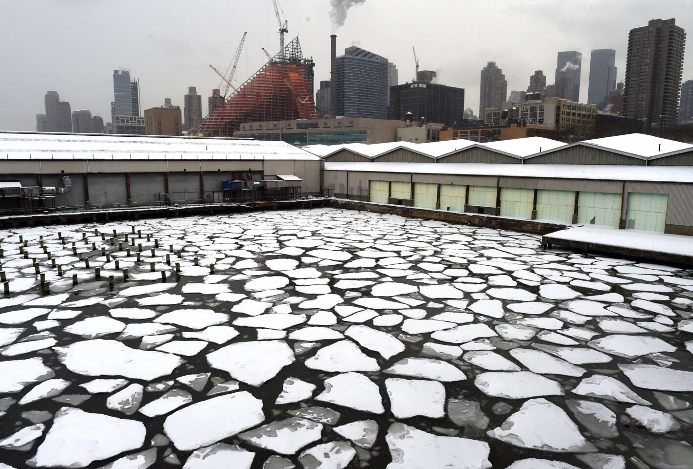 Snow-covered ice floats on the Hudson River outside of Pier 92 and Pier 94 in New York on Feb. 17.