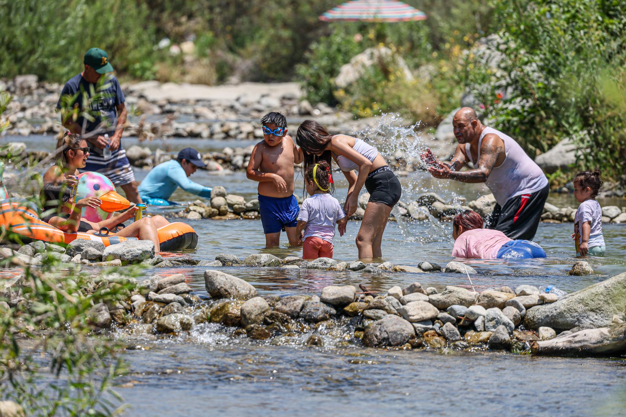 The Tujunga Wash, which is flowing with water because of winter rains, has become a hot spot for visitors this summer.