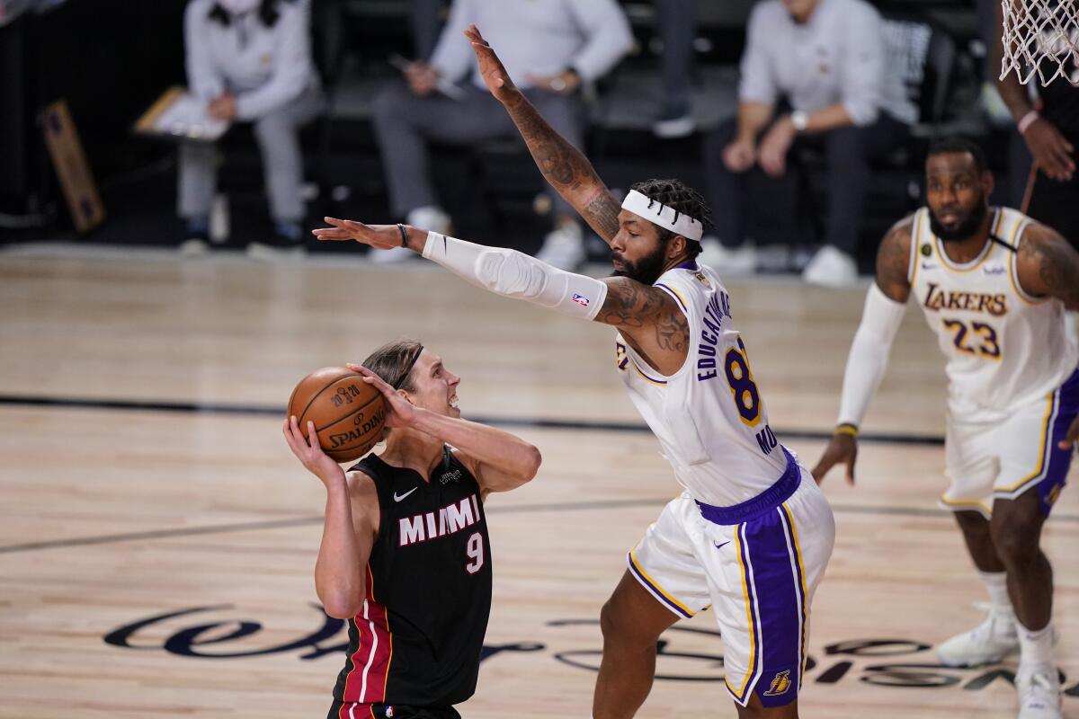 Lakers forward Markieff Morris leaps to try to block a shot by Heat center Kelly Olynyk during Game 3 on Sunday night.
