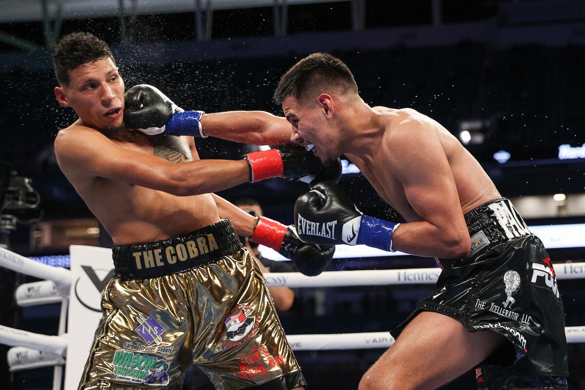 Diego Pacheco, right, punches Rodolfo Gomez Jr. during their super-middleweight fight.