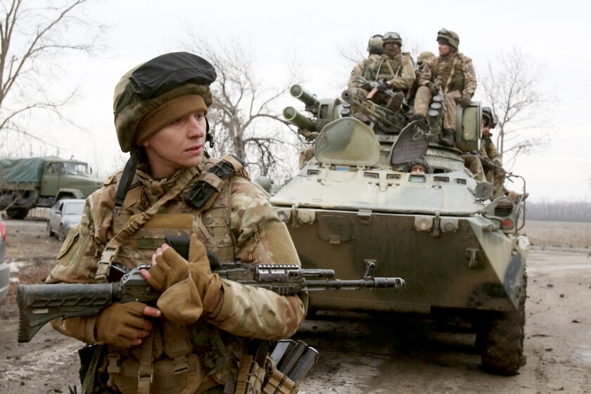 Ukrainian servicemen get ready to repel an attack in Ukraine's Lugansk region on February 24, 2022.