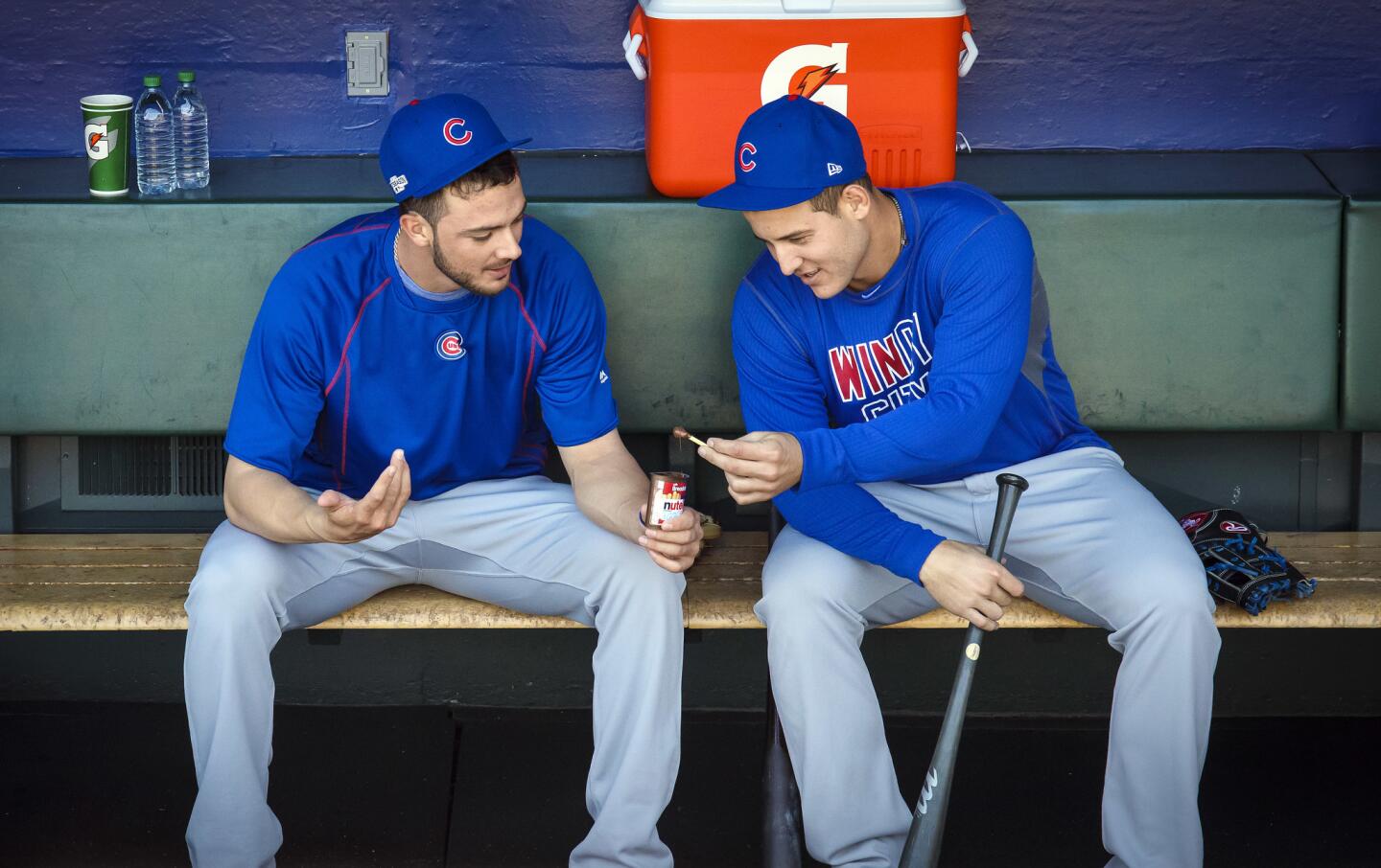 Kris Bryant and Anthony Rizzo share a snack in the dugout before their workout on Oct. 9, 2016, a day before Game 3 of their National League Division Series at AT&T Park in San Francisco.