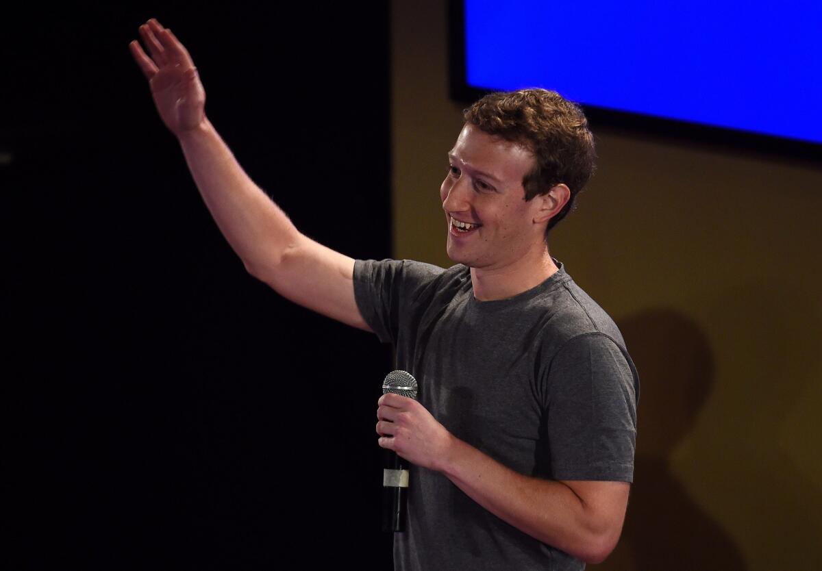 Facebook chief executive and founder Mark Zuckerberg, shown in New Delhi in October, says donating to charities is not the only way to cure disease, educate the poor and generally improve the world.
