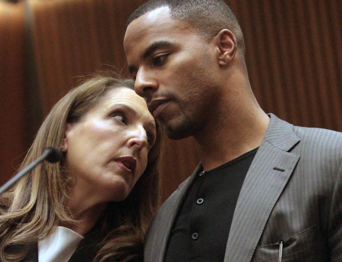 Former NFL safety Darren Sharper, right, speaks with attorney Blair Berk in Los Angeles Superior Court in February. Sharper has pleaded not guilty to charges that he drugged and raped two women he met at a West Hollywood night club.