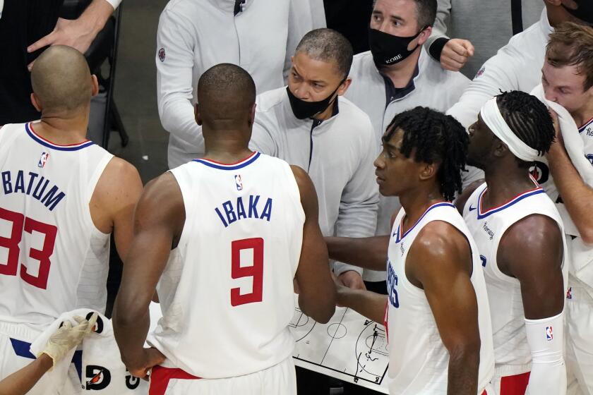 Los Angeles Clippers head coach Tyronn Lue, center, talks to his players during a timeout in the second half of an NBA basketball game against the Atlanta Hawks Tuesday, Jan. 2 6, 2021, in Atlanta. (AP Photo/John Bazemore)