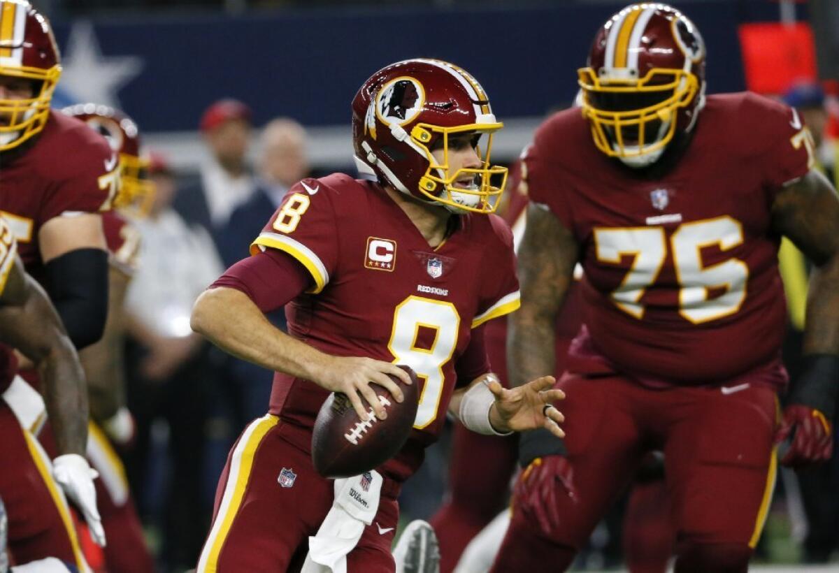 Redskins quarterback Kirk Cousins looks to pass during a game against the Cowboys on Nov. 30.
