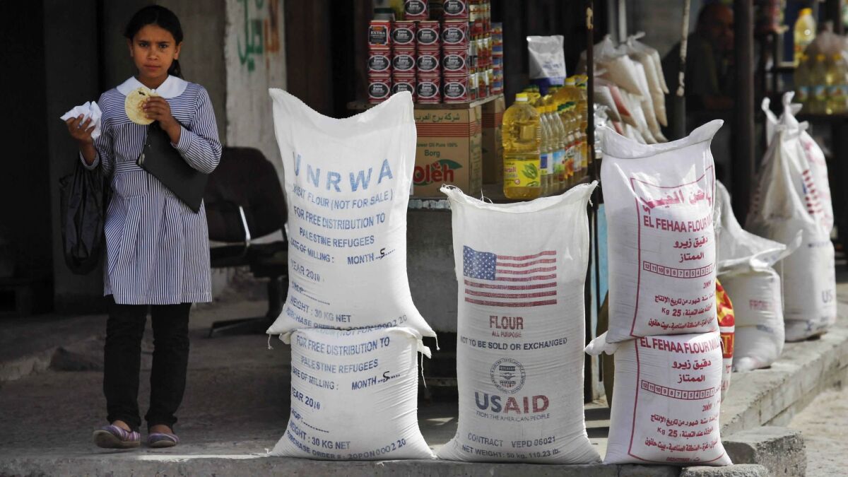 Sacks of flour, some of which were part of U.N. and U.S. humanitarian aid but are now offered for sale by a vendor, sit outside a food store in Gaza City.