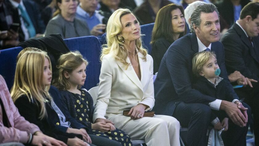 California Governor Gavin Newsom, right, sits with his family: (L to R) Montana, Hunter, Brooklynn, First Partner Jennifer Siebel Newsome,and Dutch, during the inauguration ceremony on Monday, Jan. 7, 2019 in Sacramento, Calif.