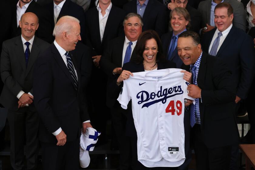 WASHINGTON, DC - JULY 02: Los Angeles Dodgers Manager Dave Roberts presents U.S. Vice President Kamala Harris with a jersey as she and President Joe Biden host the 2020 World Series champions in the East Room of the White House on July 02, 2021 in Washington, DC. The Dodgers defeated the Tampa Bay Rays to win the championship series at the end of an abbreviated season due to the coronavirus. (Photo by Chip Somodevilla/Getty Images)