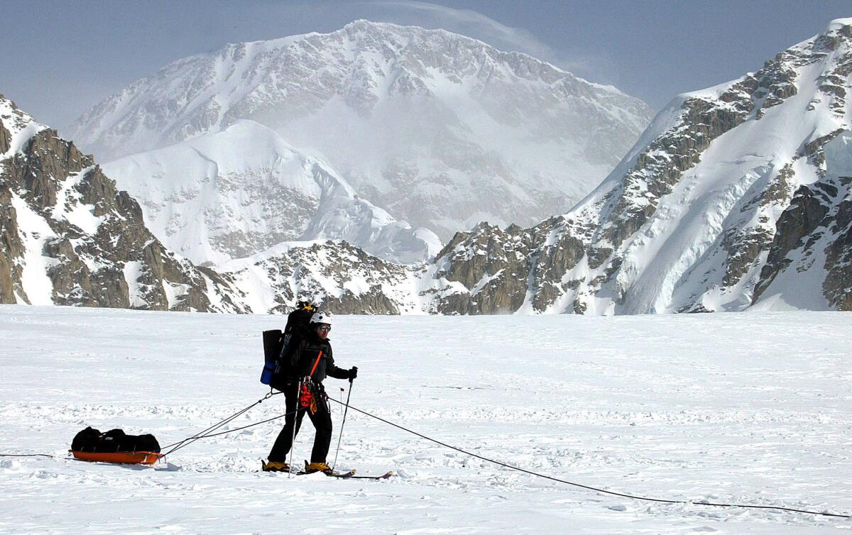 A skier moves across the Kahiltna Glacier in Alaska with Mt. McKinley in the background in 2002.