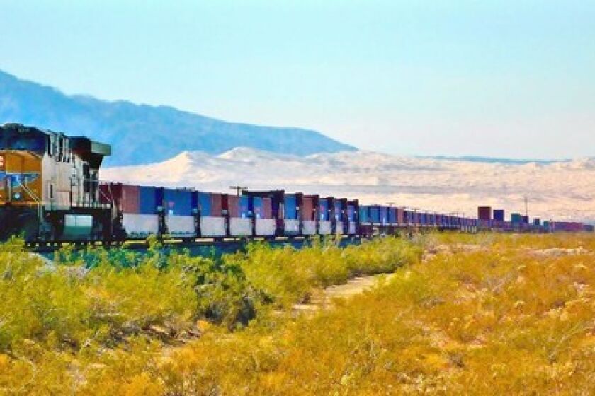 A Union Pacific freight train is an hourly sight — and sound — in the Mojave National Preserve. The wind-carved singing Kelso Dunes are in the background.