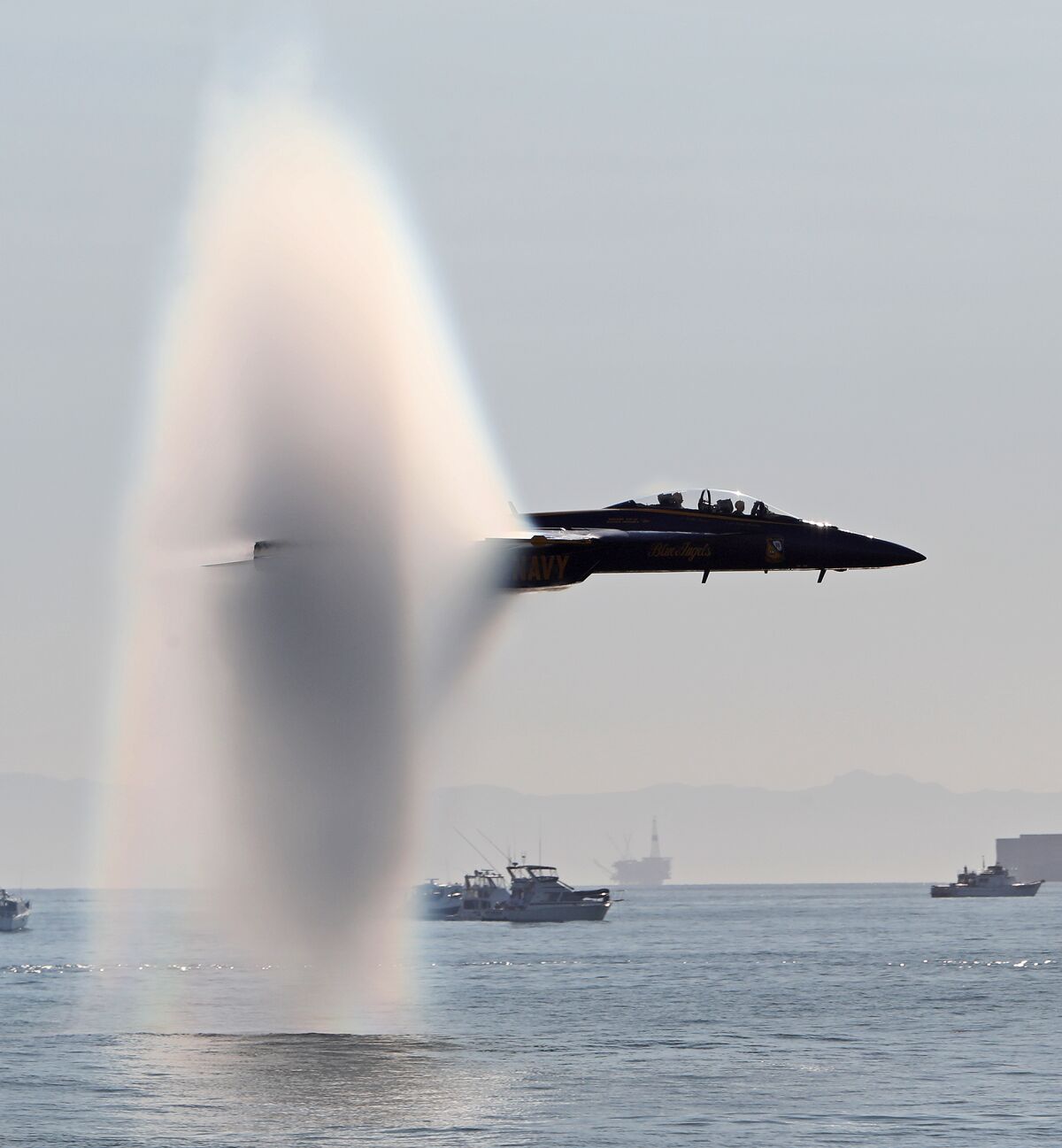 A U.S. Navy Blue Angels team member comes in low on the first day of the Pacific Airshow.