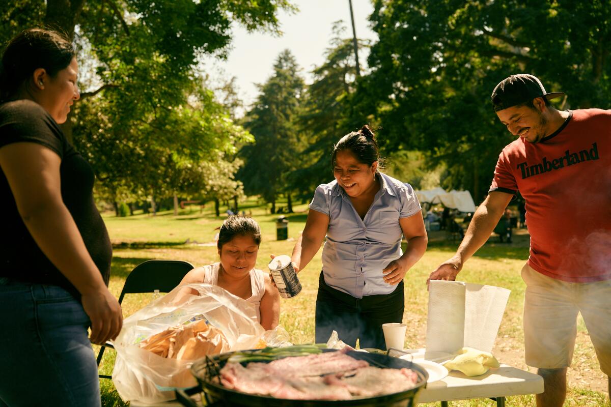 An L.A. family cooks a carne asada at Elysian Park. (Shelby Moore / For The Times)