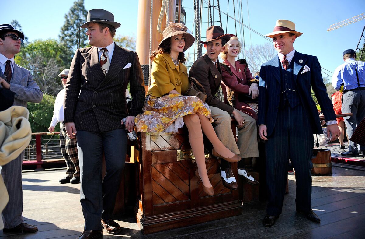 Participants dressed in vintage style gather at the sailing ship Columbia at Disneyland.