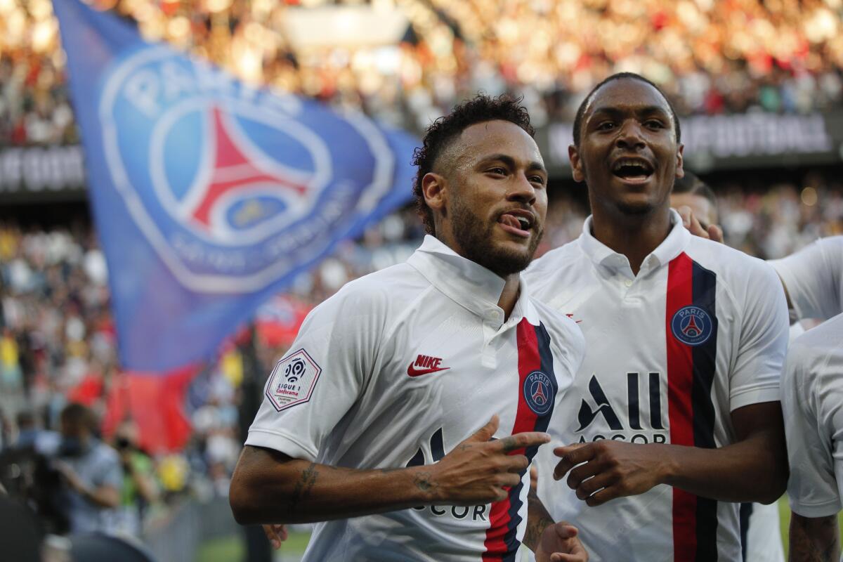 PSG's Neymar celebrates his goal during the French League One soccer match between Paris Saint Germain and Strasbourg at the Parc des Princes Stadium in Paris, France, Saturday Sept.14, 2019. (AP Photo/Francois Mori)