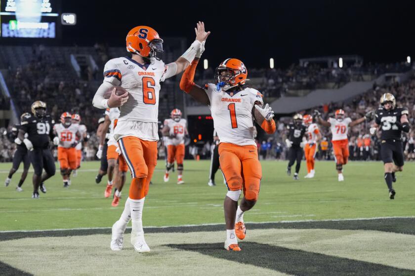 Syracuse quarterback Garrett Shrader (6) is congratulated by LeQuint Allen Jr. (1) after scoring a touchdown against Purdue during the second half of an NCAA college football game in West Lafayette, Ind., Saturday, Sept. 16, 2023. (AP Photo/AJ Mast)