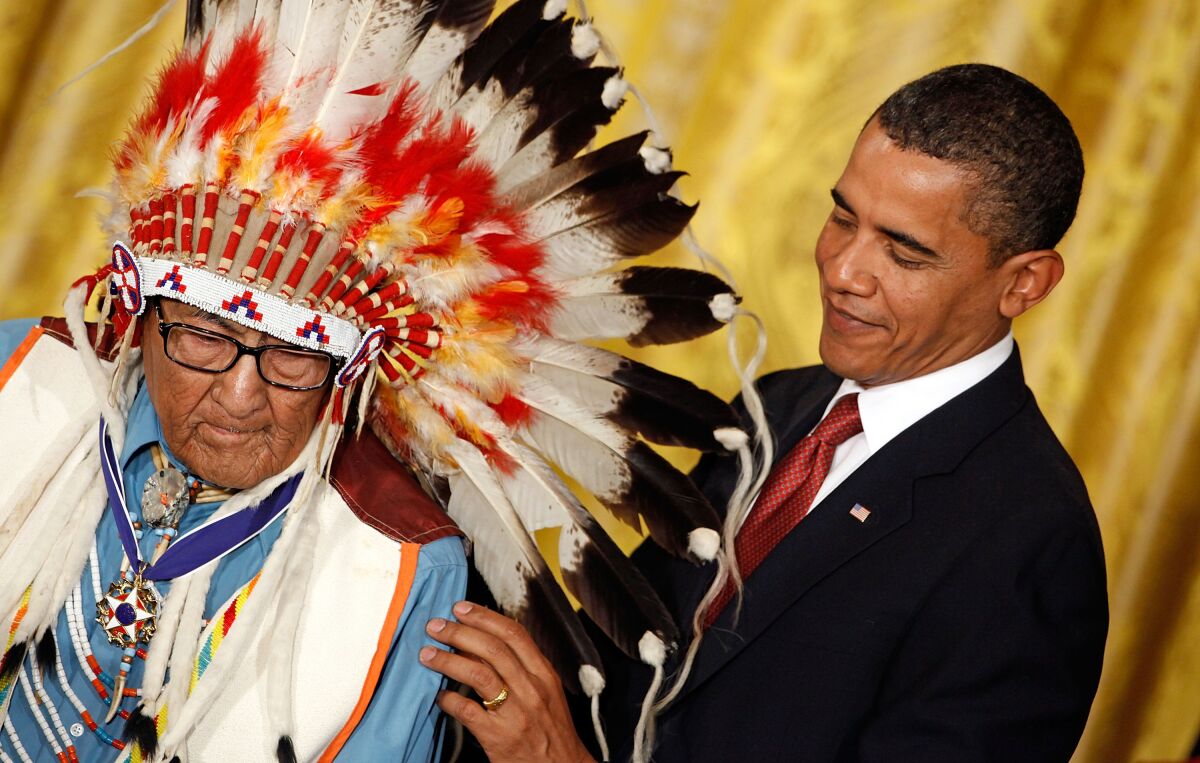 President Barack Obama presents a medal to Joseph Medicine Crow
