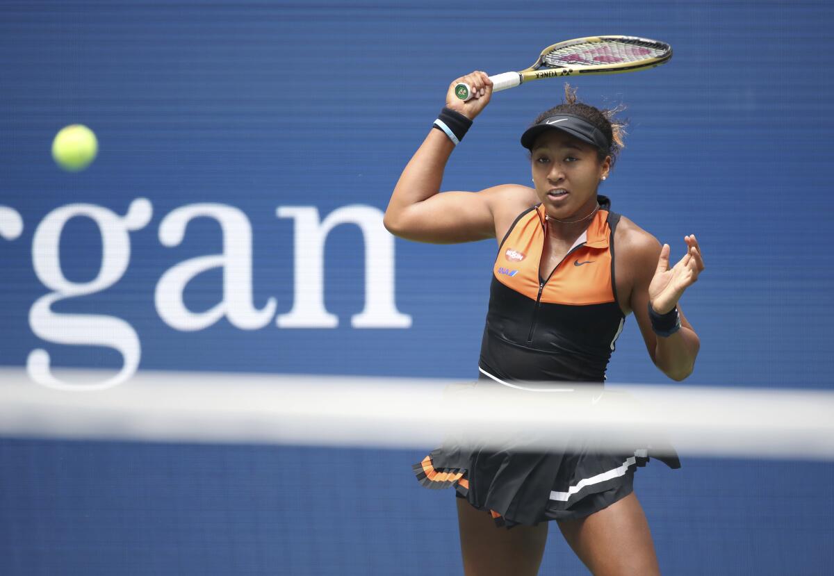 Naomi Osaka returns a shot during her first-round victory over Anna Blinkova at the U.S. Open on Tuesday.