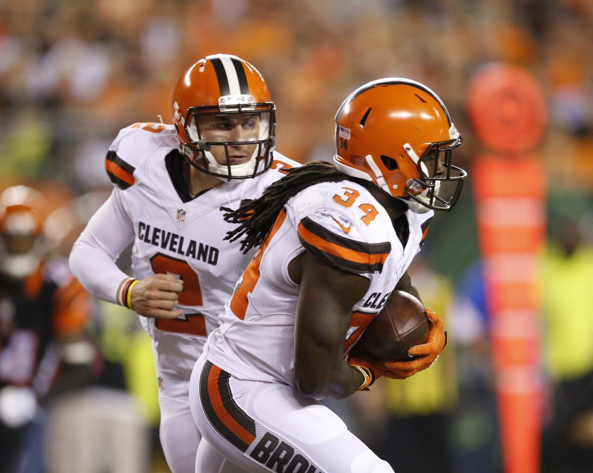 Cleveland running back Isaiah Crowell takes the handoff from quarterback Johnny Manziel during the second half of a game against Cincinnati on Nov. 5.