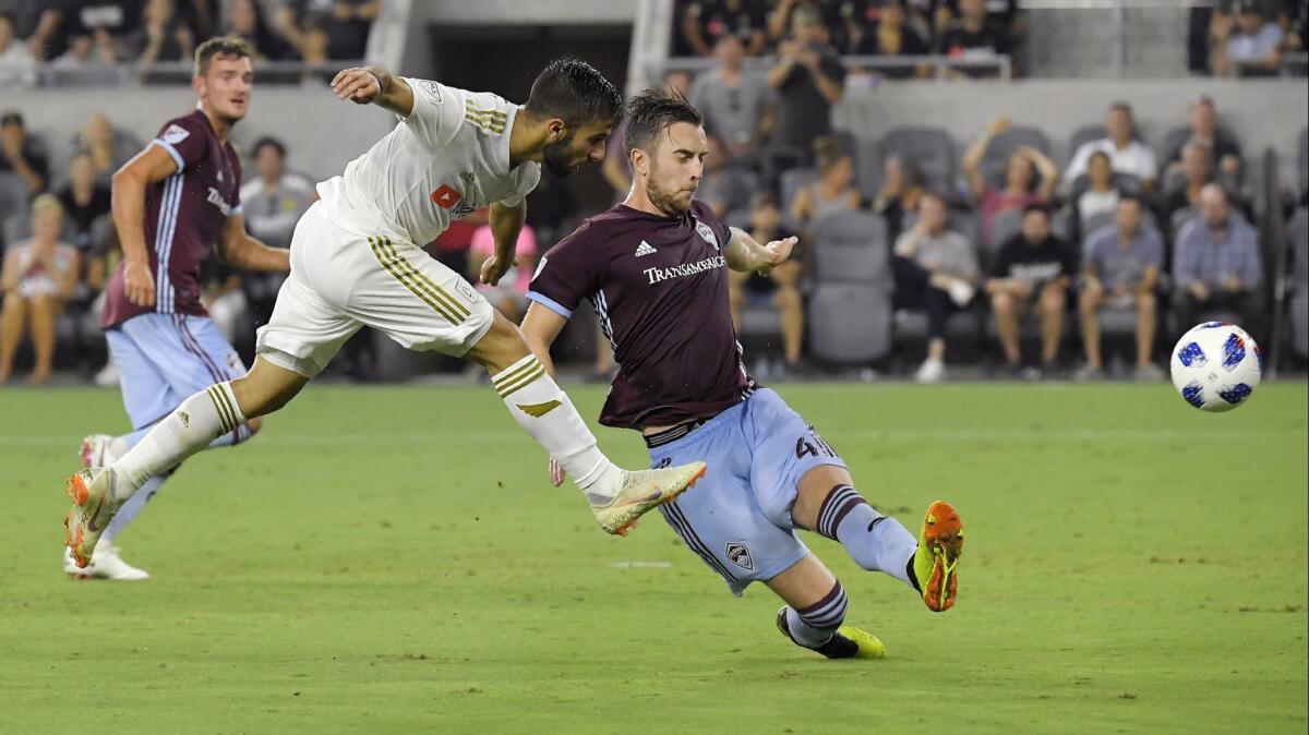 LAFC forward Diego Rossi, center, scores past Colorado Rapids defender Danny Wilson during the second half of a match on Sunday.