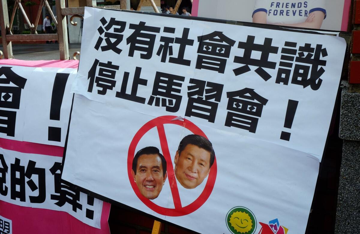 A placard against the meeting between Taiwan's President Ma Ying-jeou and his Chinese counterpart Xi Jinping is placed at the main entrance during a demonstration outside the parliament in Taipei.
