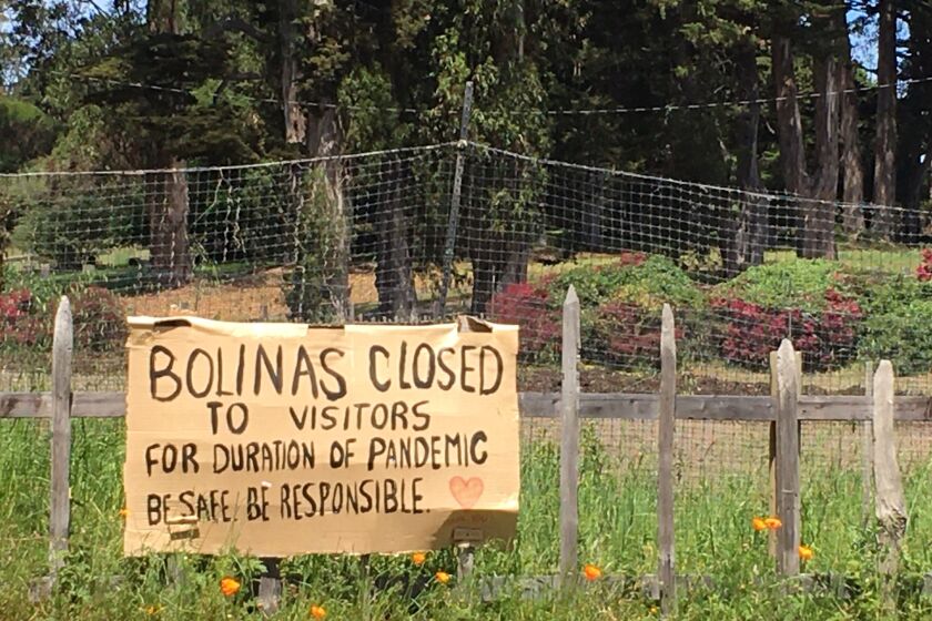 A sign hangs outside of Bolinas, warning visitors to stay away, on Monday, April 27, 2020.