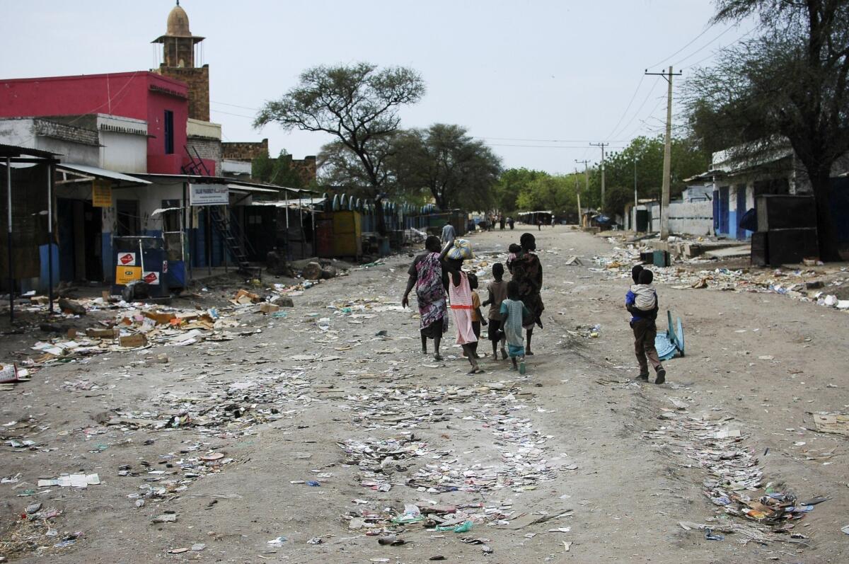 A family walks down a deserted street in the South Sudan town of Malakal last month.
