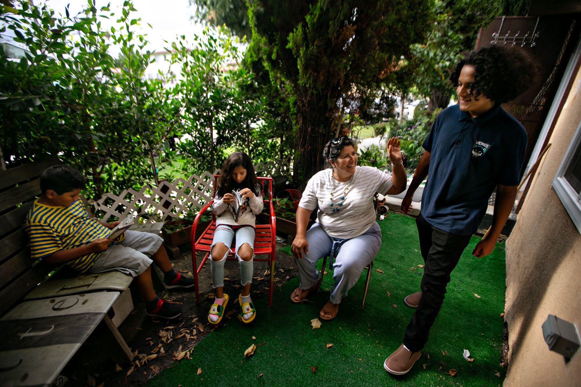 Luz Puebla and her children hang out in their small courtyard 