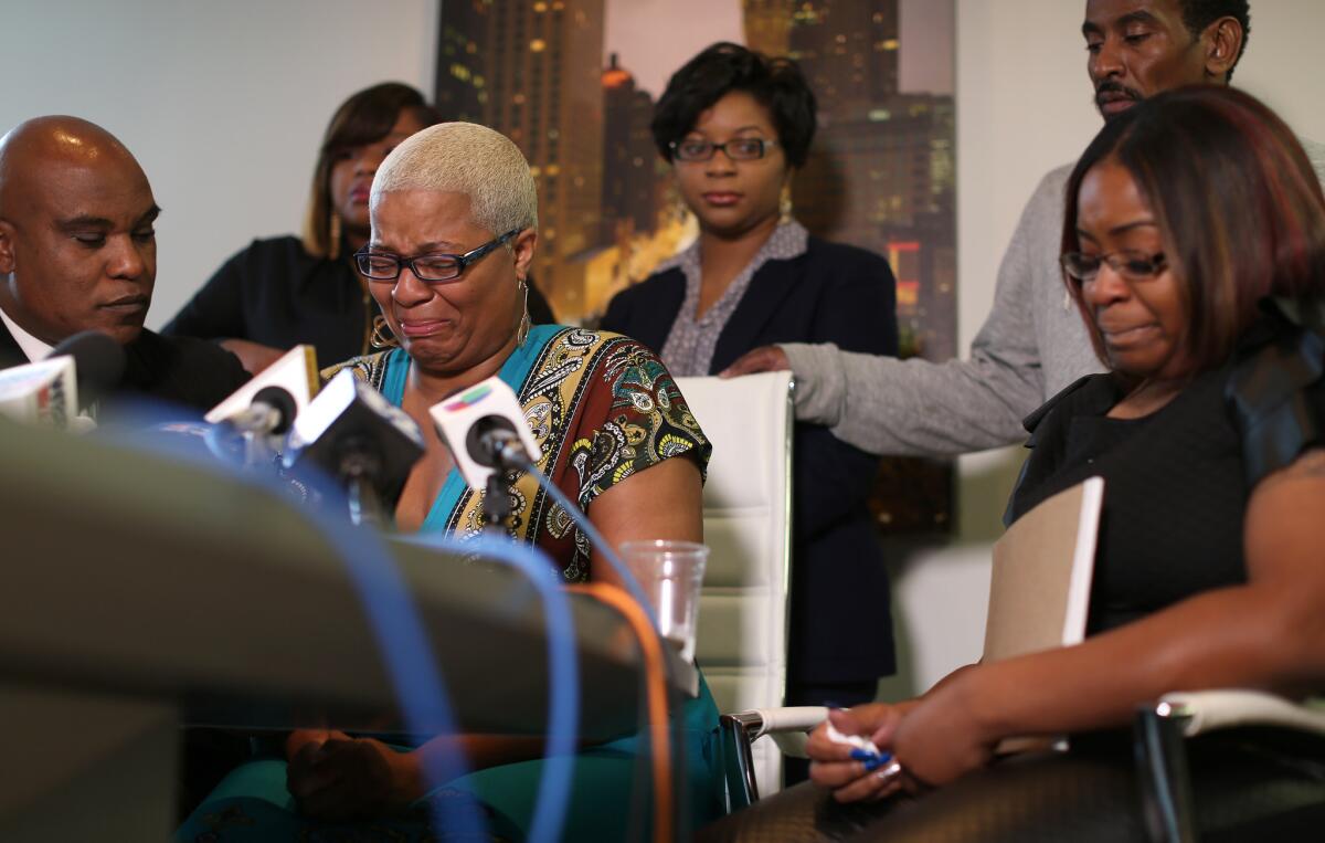 Sandra Bland's sisters hold a news conference in Chicago on Thursday. Her oldest sister, Shante Needham, is shown at center. At right is Sierra Cole, and in back, from left, are Shavon Bland and Sharon Cooper. Also shown is their attorney, Cannon Lambert, left, and their uncle, Paul Needham, back right.