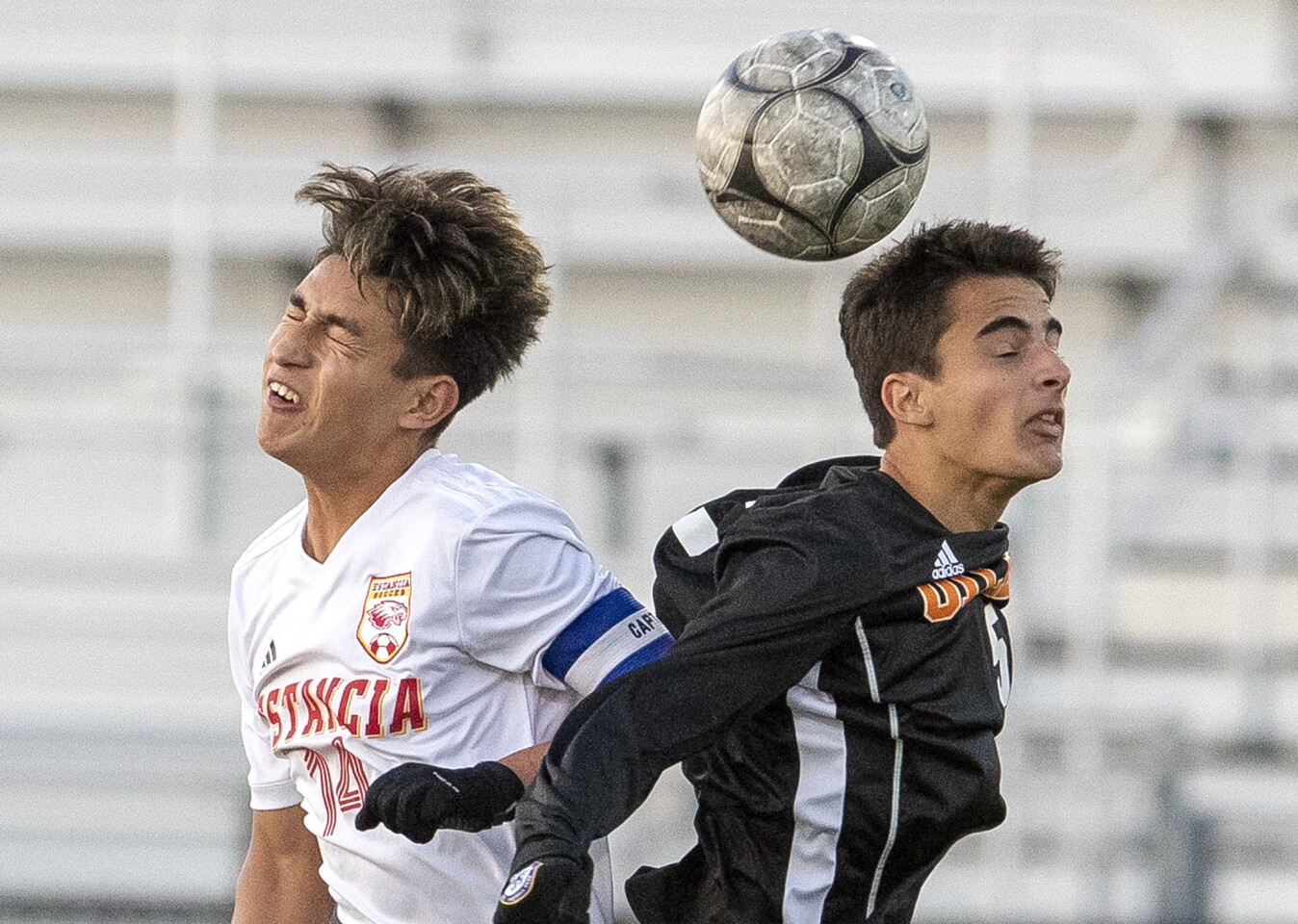 Estancia High's Brian Alvarez, left, goes up for a header against Huntington Beach's Jason Gunn during the first round of the CIF Southern Section Division 2 playoffs at Cap Sheue Field on Thursday.