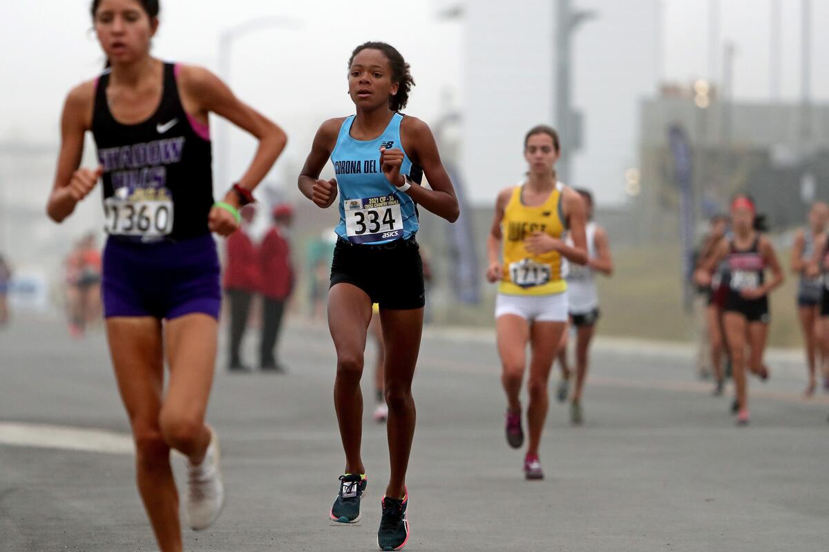 Corona del Mar sophomore Melisse Djomby-Enyawe (334) competes in the girls' Division 3 race during the CIF finals.