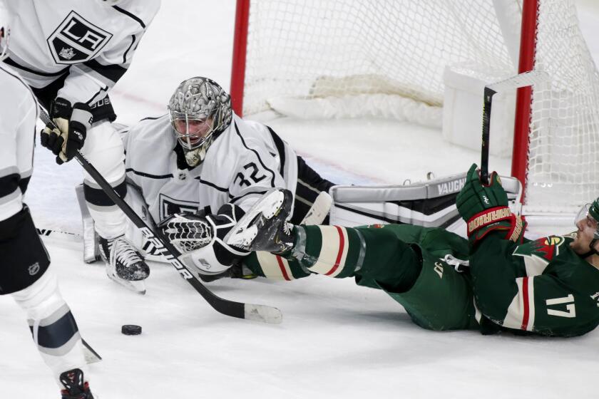 Minnesota Wild left wing Marcus Foligno (17) falls after a shot on Los Angeles Kings goalie Jonathan Quic.