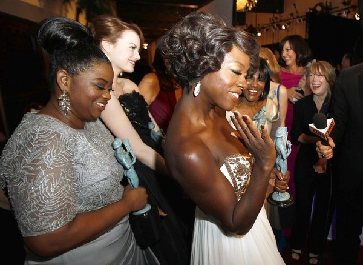 SAG award winners Octavia Spencer, left, and Viola Davis, center, at the Screen Actors Guild Awards show in Los Angeles.