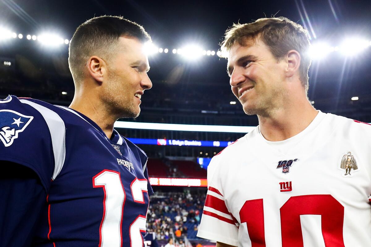 New England Patriots quarterback Tom Brady greets New York Giants QB Eli Manning after a preseason game Aug. 29, 2019