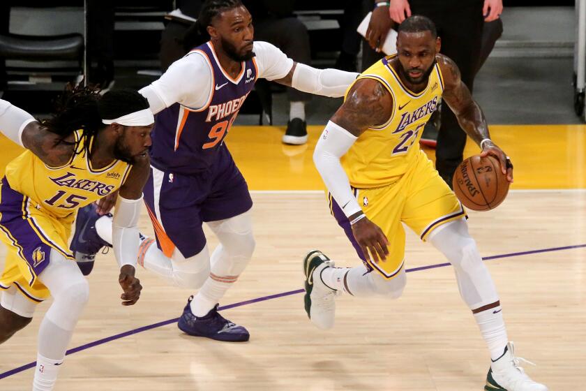 LOS ANGELES, CA - JUNE 03:. Lakers forward LeBron James moves the ball upcourt against the Suns during the first quarter at Staples Center on Thursday, June 3, 2021 in Los Angeles, CA. (Luis Sinco / Los Angeles Times)