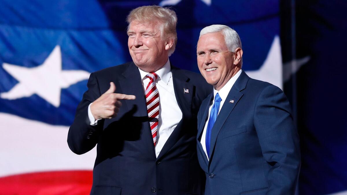 Donald Trump points toward Gov. Mike Pence of Indiana after Pence's speech at the Republican National Convention.