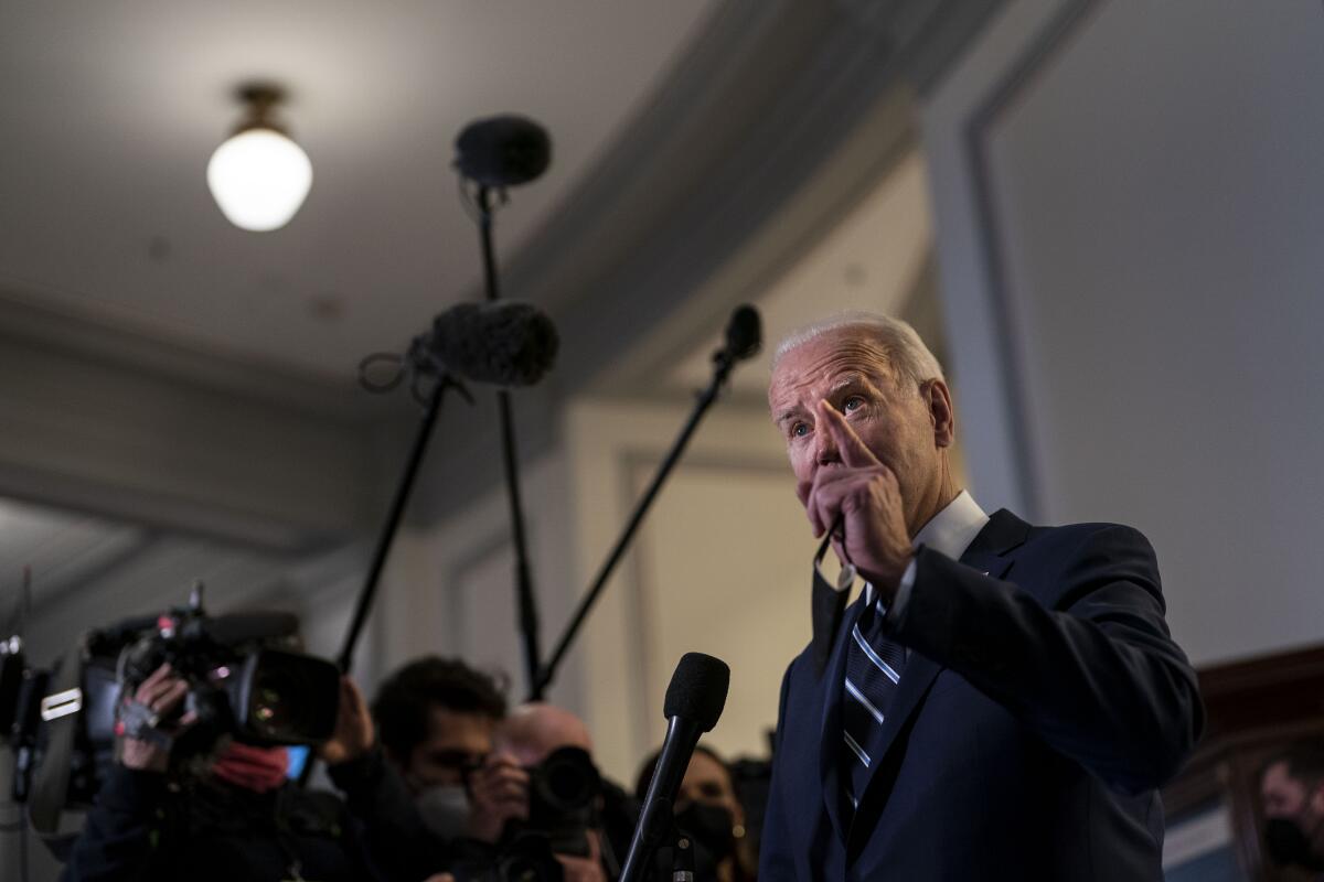 President Biden speaks to reporters after meeting with Senate Democrats at the Capitol on Jan. 13. 