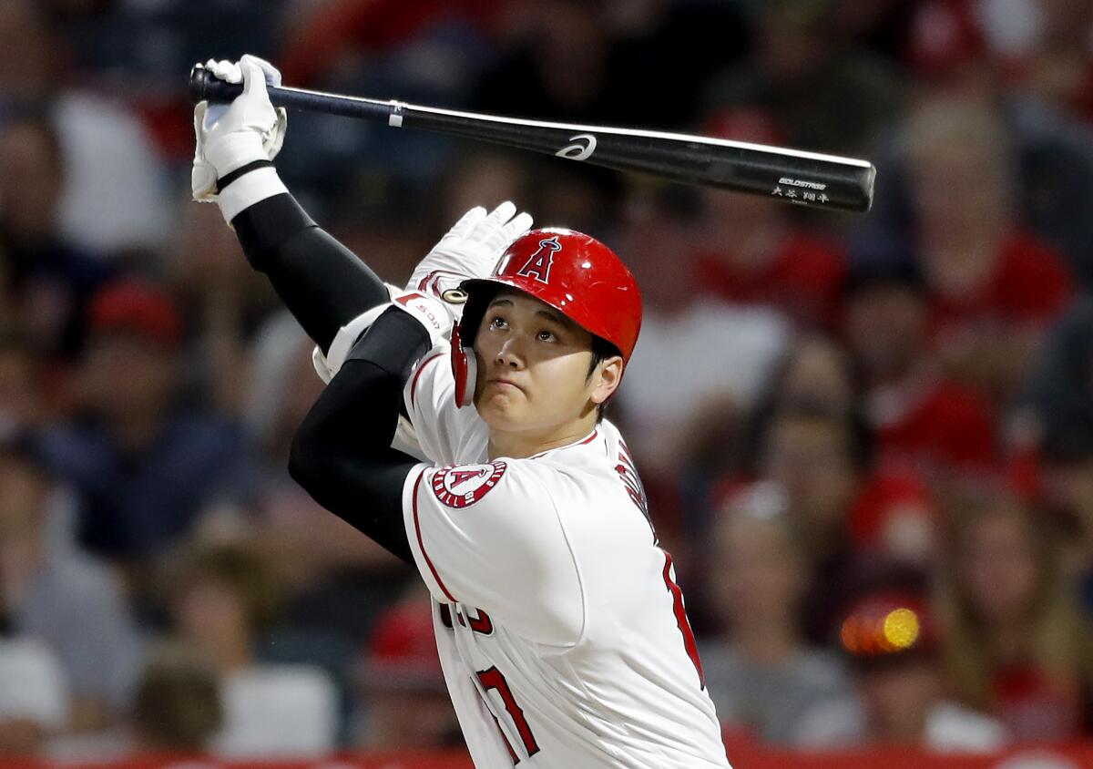 Angels designated hitter Shohei Ohtani hits a triple against the Pirates during a game on Aug. 13 in Anaheim.
