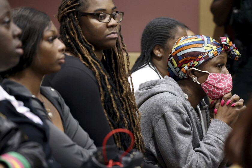 Kia Smith, right, awaits word from the jury during the murder trial of Dayonte Resiles at the Broward County Courthouse where jurors finished deliberations without reaching a unanimous decision on Wednesday, Dec. 8, 2021, in Fort Lauderdale, Fla. Resiles, 27, remains charged with first-degree murder and manslaughter in the killing of Jill Halliburton Su, during a burglary of her Fort Lauderdale home on Sept. 8, 2014. (Amy Beth Bennett/South Florida Sun-Sentinel via AP)