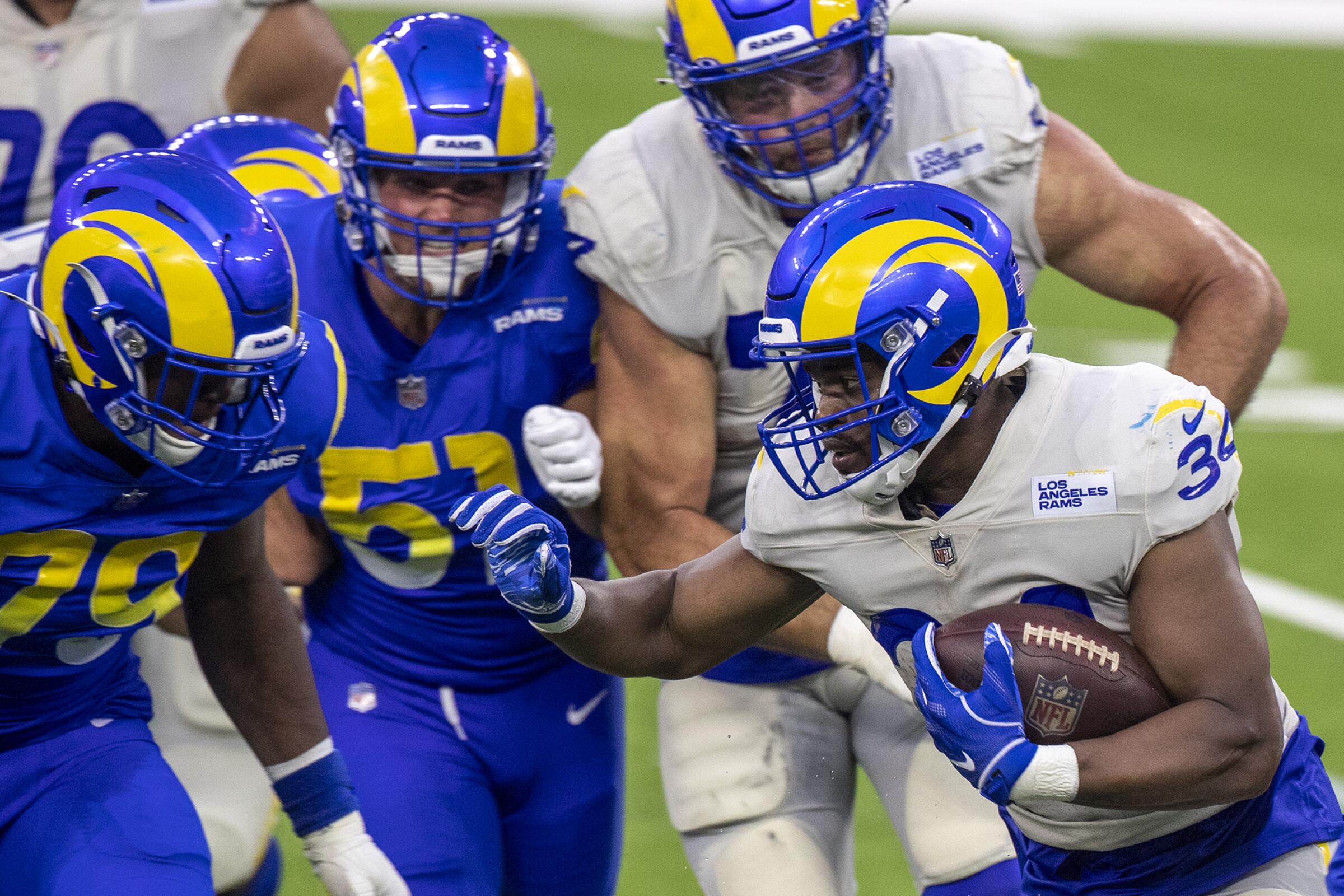 Rams running back Malcolm Brown runs with the ball during a team scrimmage at SoFi Stadium.