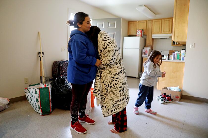 PLANADA, CA - JANUARY 18: Erica Bedolla Lopez, 35, left, her husband Eric Lopez and three children had to evacuate to temporary housing at the Felix Torres Farmworker Family Housing Center, after their home was severely flooded from last week's storm on Wednesday, Jan. 18, 2023 in Planada, CA. Erica, left, is shown with daughers Miley Lopez, 10, center, and Leanie (cq) Lopez, 4, at the temporary housing. Around 40 evacuated families have been granted 45 days to stay at the housing center. Last week's storms led the Planada Canal and Miles Creek to overflow and flood the town of Planada. Around 40 evacuated families have been placed at the housing center. The people of Planada are making their way home after last week's storm flooded the town (KFSN-TV ABC30 News). California bracing for one final round of atmospheric river storms as officials assess damage. (Gary Coronado / Los Angeles Times)