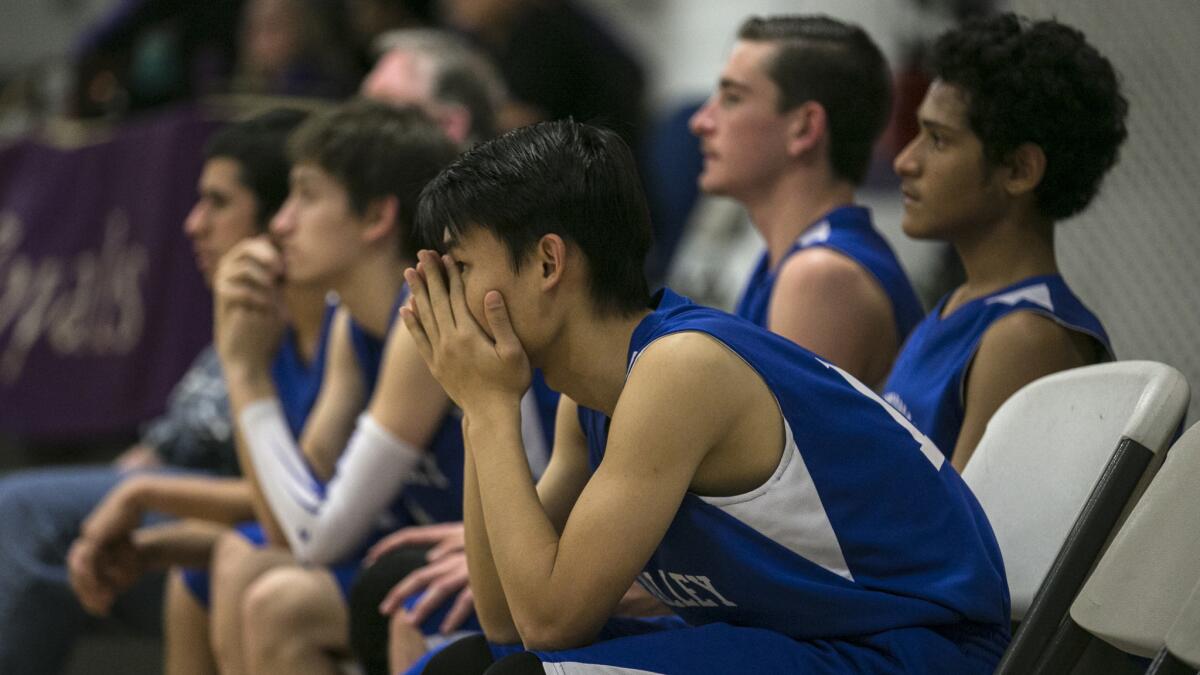 Tristian Qiu, center, watches as his team encounters difficulty down the stretch.