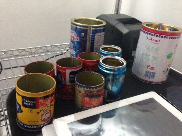 Recycled tobacco tins used to give customers their checks.