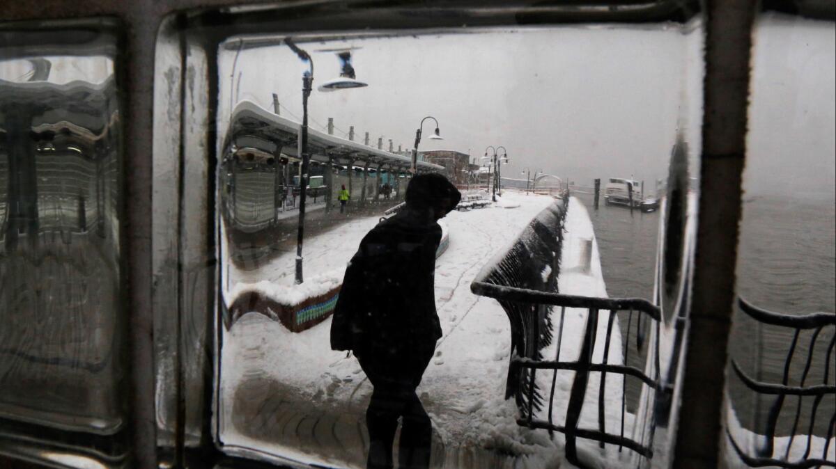 A man is seen through the glass as he walks along the Hoboken train terminal in New Jersey.