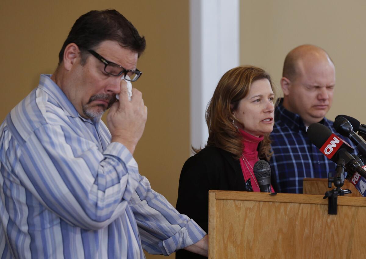 Will Corporon, left, and Tony Corporon, right, fight emotions while Mindy Losen talks about her son and father during a news conference at their church in Leawood, Kan.
