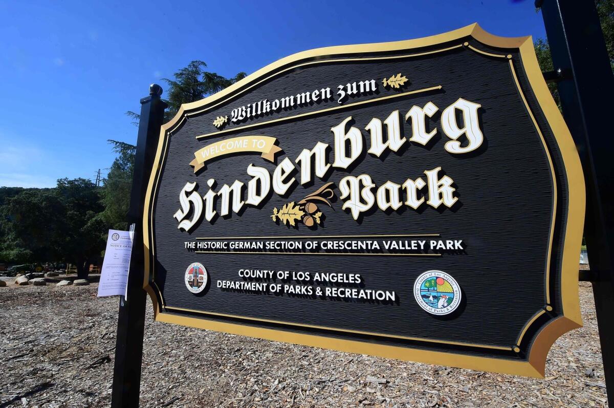 A notice of public hearing from the Los Angeles County Human Relations Commission is taped onto the Hindenburg Park sign at Crescenta Valley Park in La Crescenta.