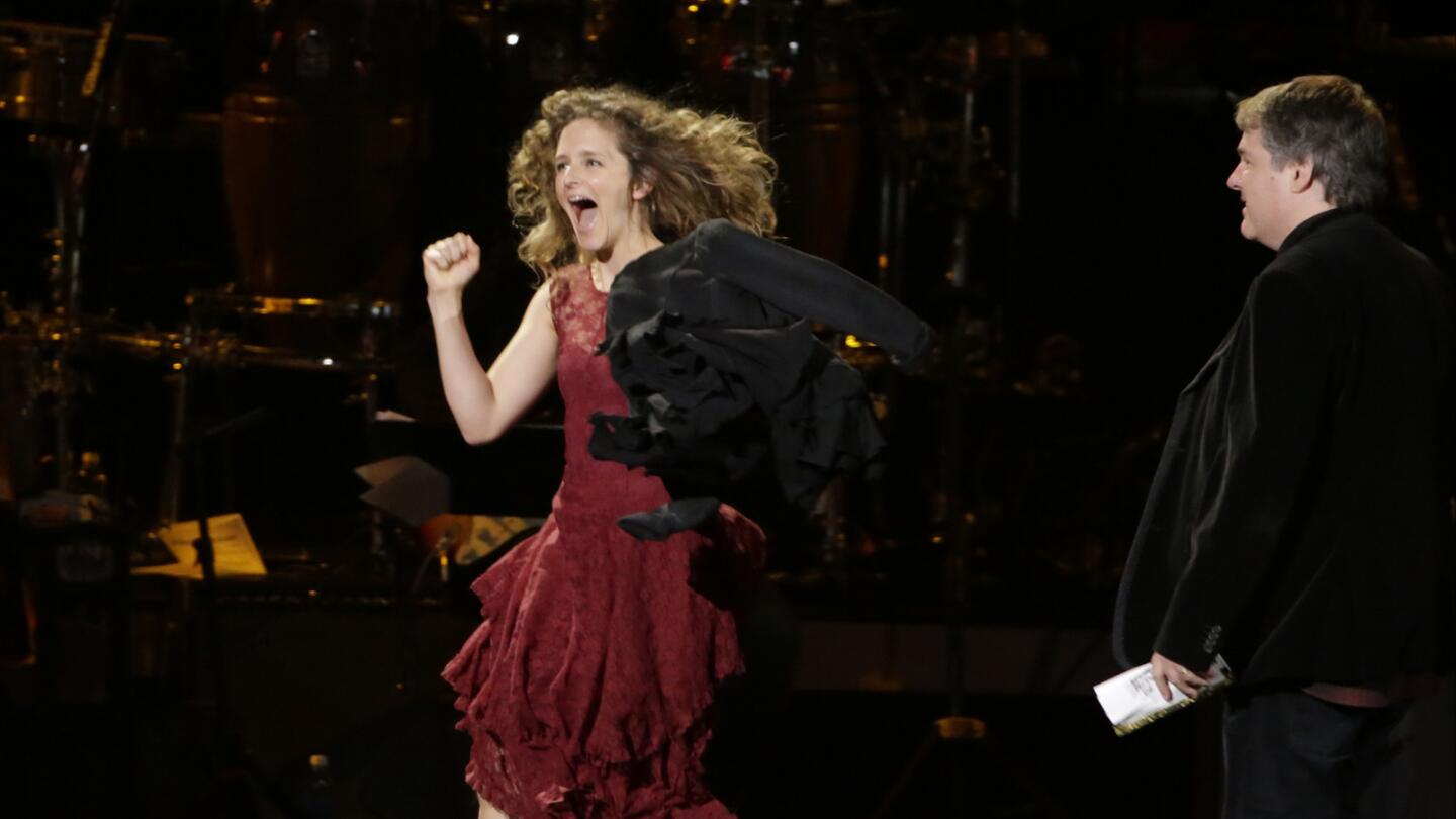 Abigail Washburn and Bela Fleck head for the stage to accept their Grammy for folk album at the pre-telecast show.