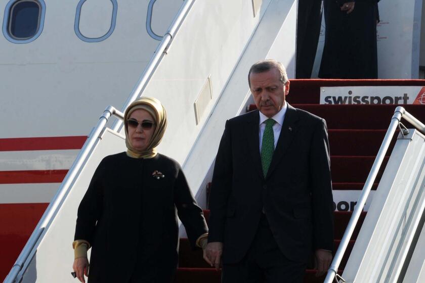 Turkish President Recep Tayyip Erdogan, shown here on Wednesday arriving in Algiers with his wife, Emine, calls motherhood women's highest role and urges Turkish women to have at least three children.