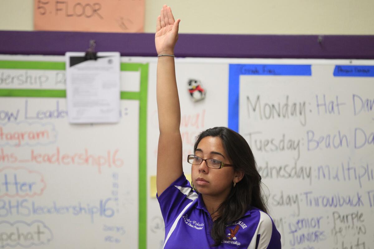 Dulce Penuelas, 17, raises her hand during leadership class at Bell High School, in Bell, Calif. Latino and black students who passed their Advanced Placement tests outperformed their peers, new exam scores show.