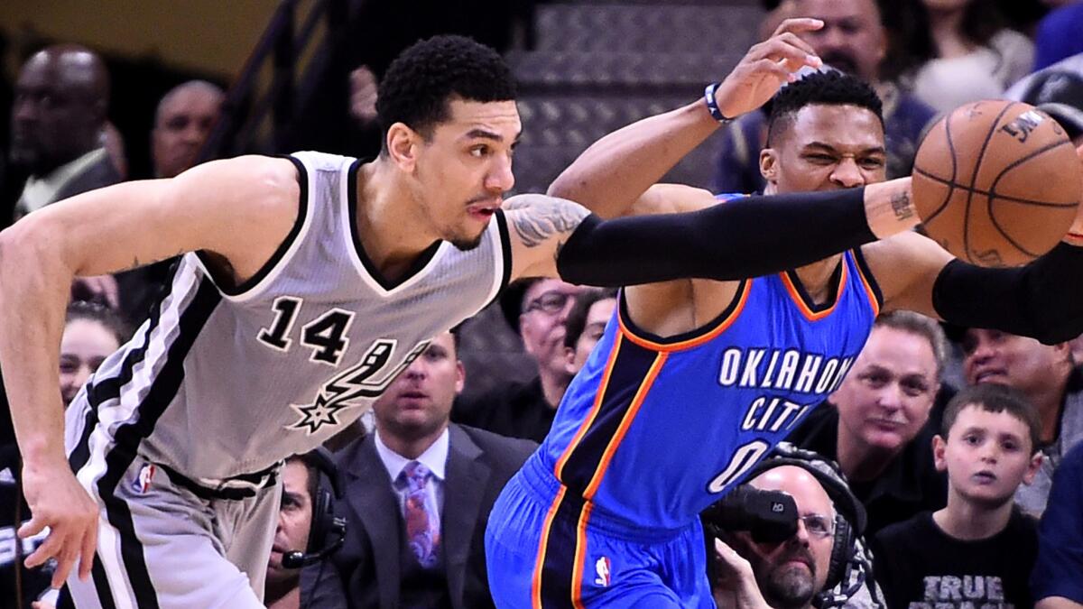 Spurs guard steals the ball from Thunder guard Russell Westbrook during the first half Saturday.